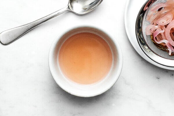A small bowl of infused vinegar for bearnaise sauce