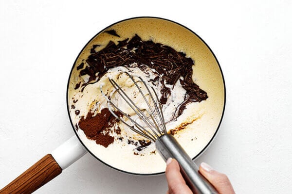 Stirring chocolate and milk for chocolate pots de creme