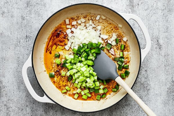 Cooking veggies in a pan for cajun chicken