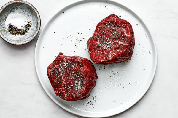 Salt and pepper on filet mignon steaks