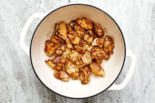 Sauteing chicken in a pot for jambalaya