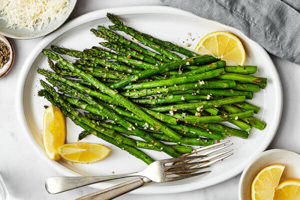 A white plate of air fryer asparagus