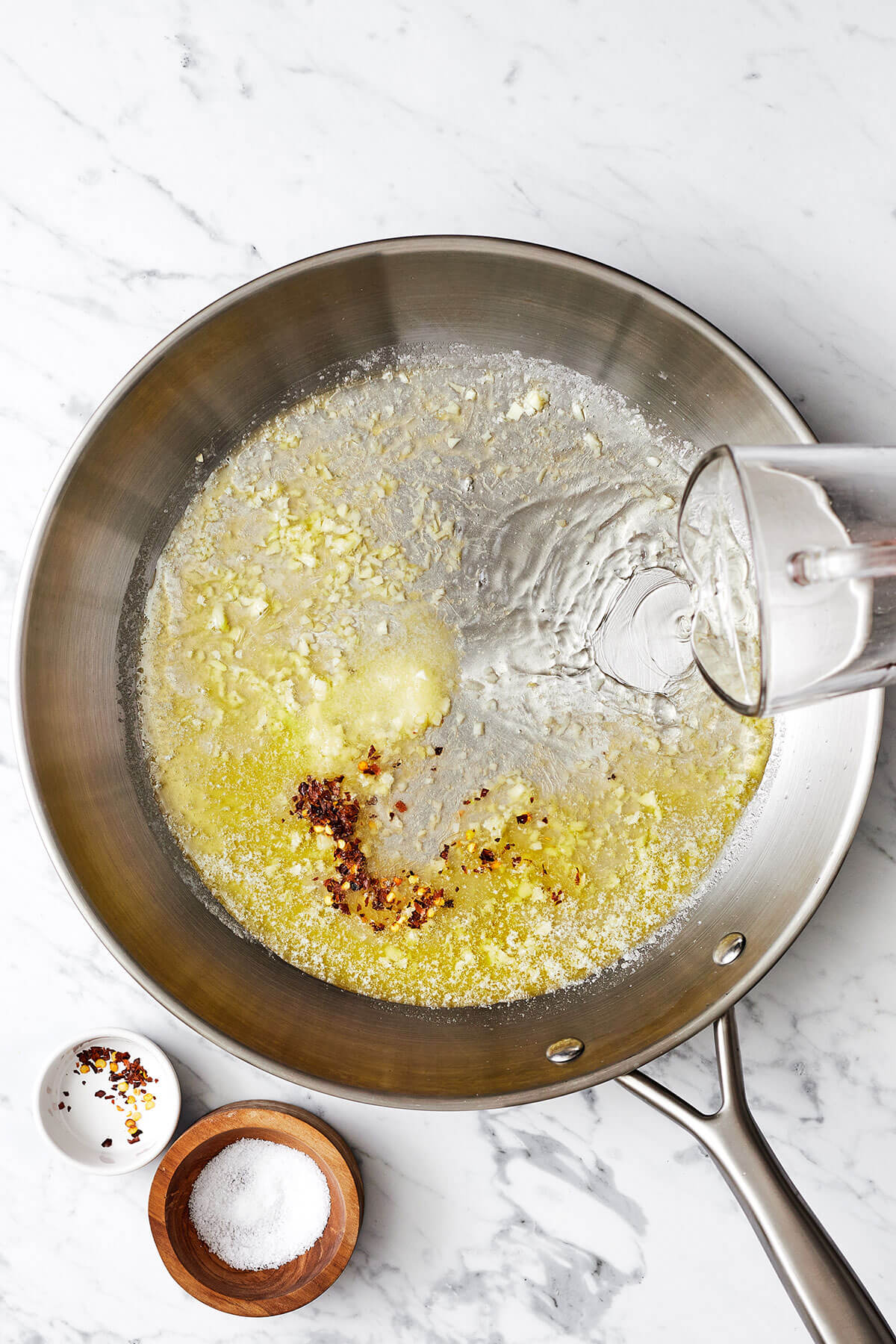 Making shrimp scampi sauce in a pan