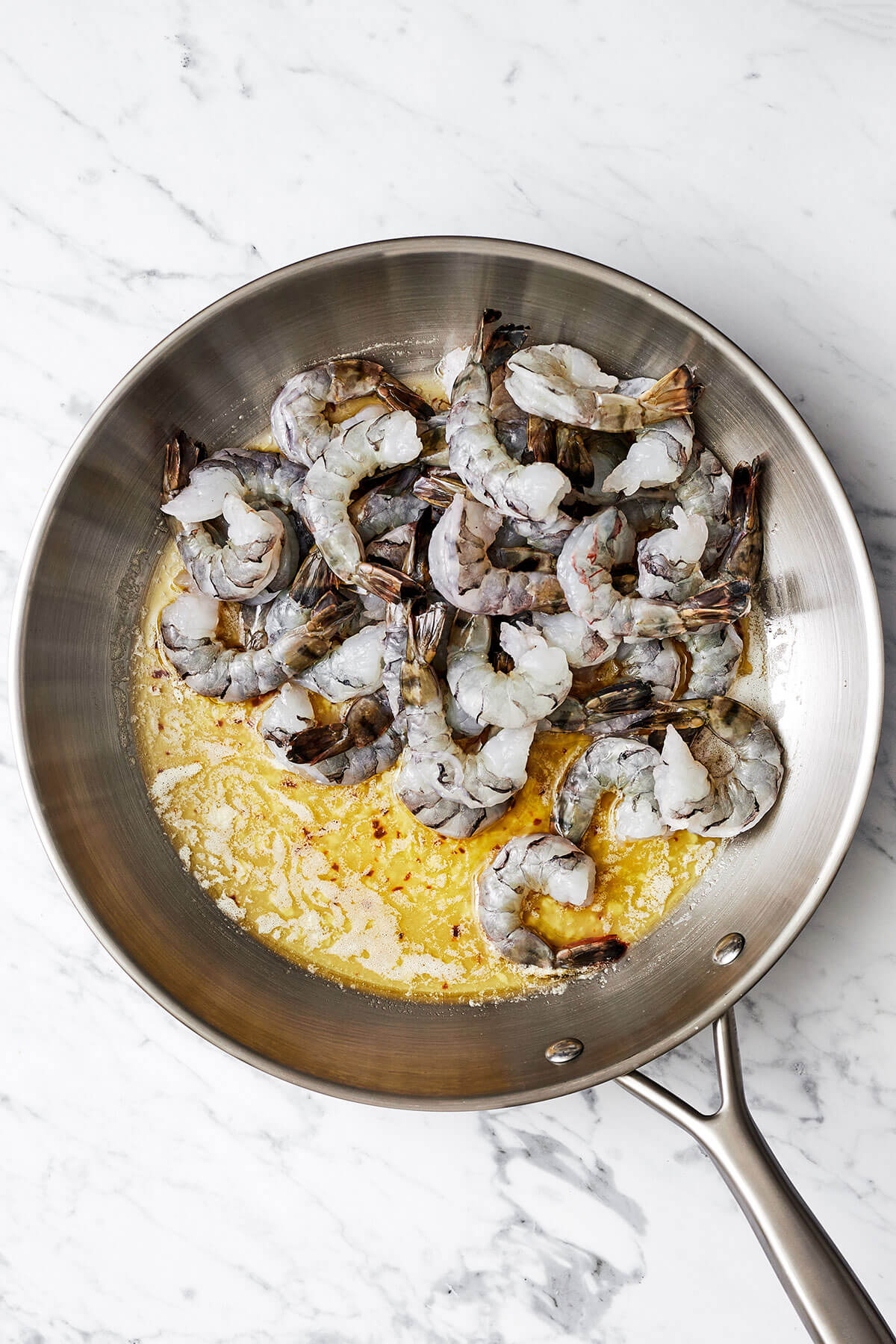 Cooking shrimp in a pan for shrimp scampi