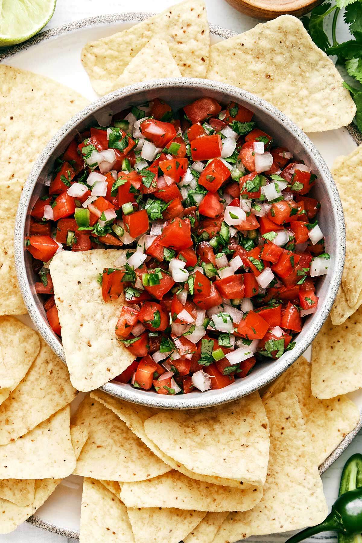 Pico de gallo in a bowl with chips.