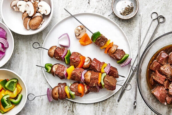 Threading shish kabob on a skewer