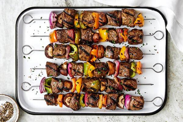 A tray of beef shish kabobs