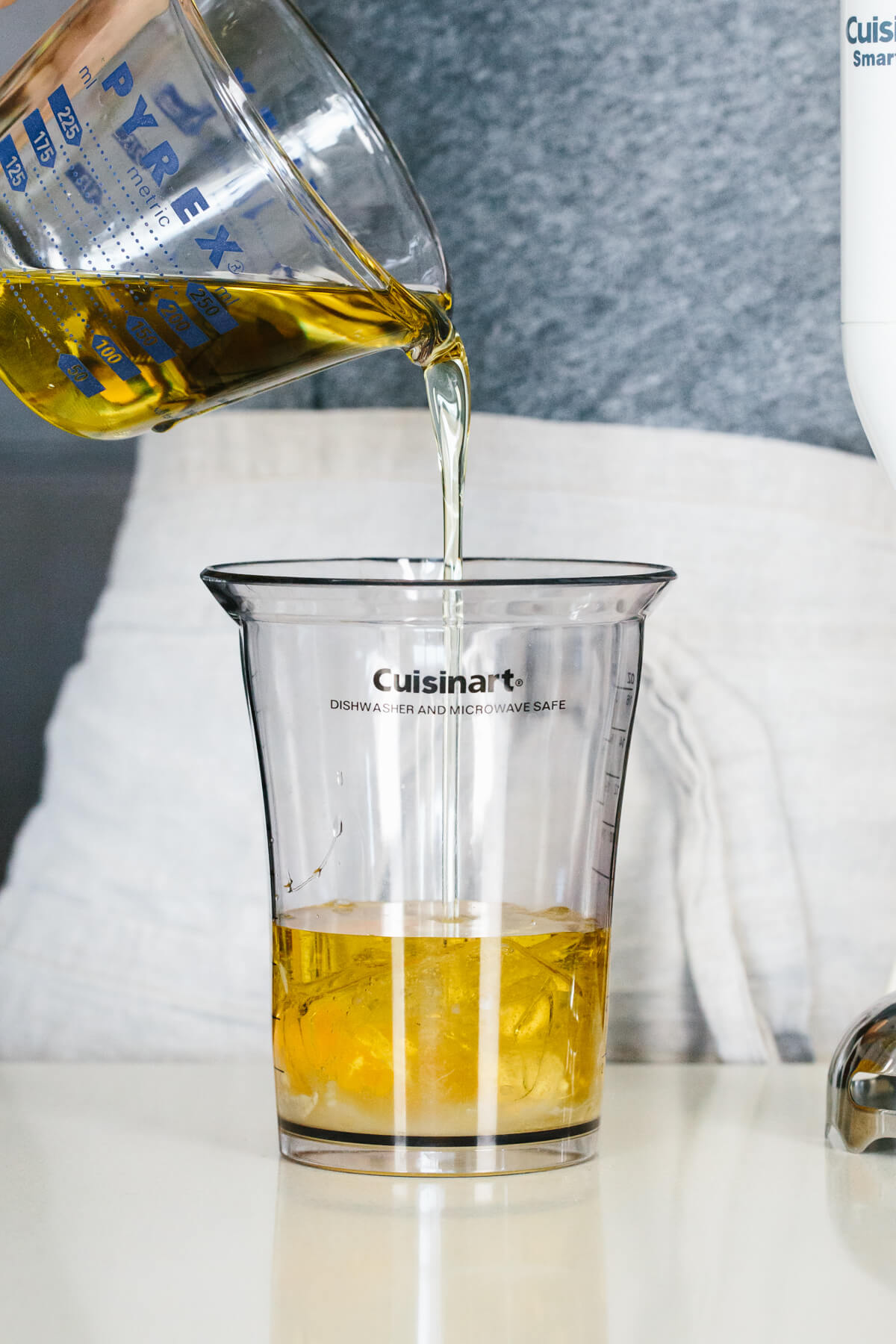 Adding mayonnaise ingredients to a jar.