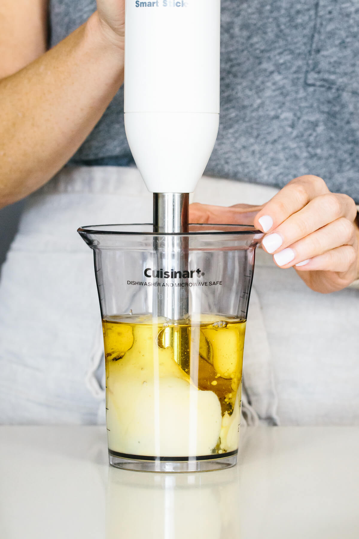Blending mayo with a stick blender.