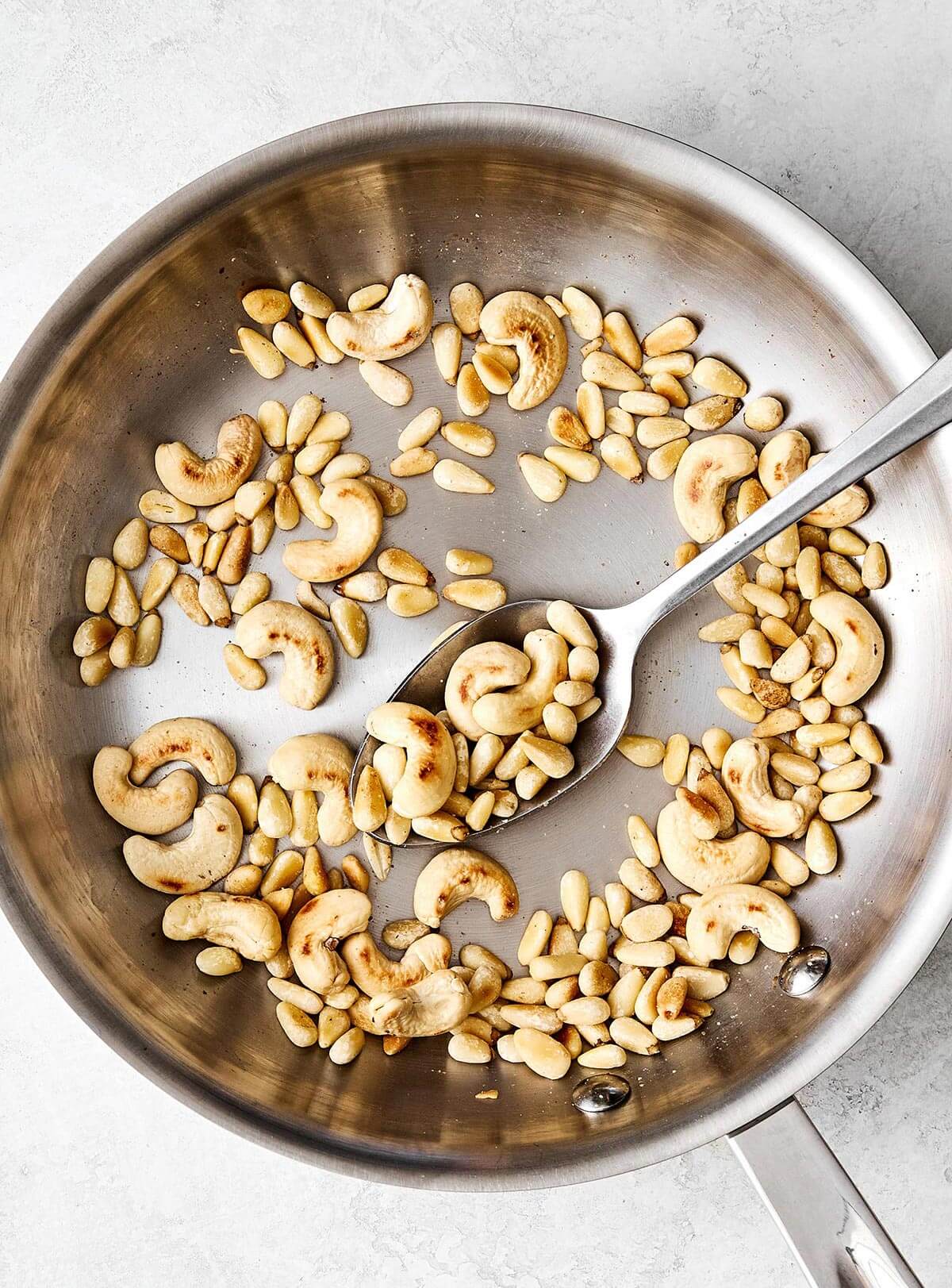 Toasting nuts in a pan for pesto.