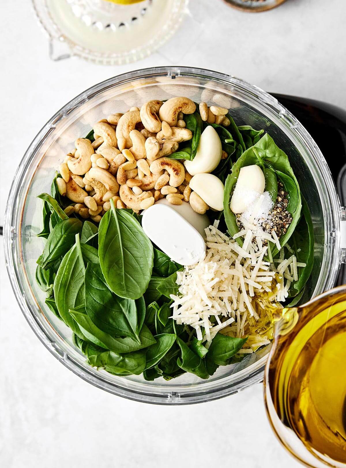 Blended basil pesto sauce in food processor.