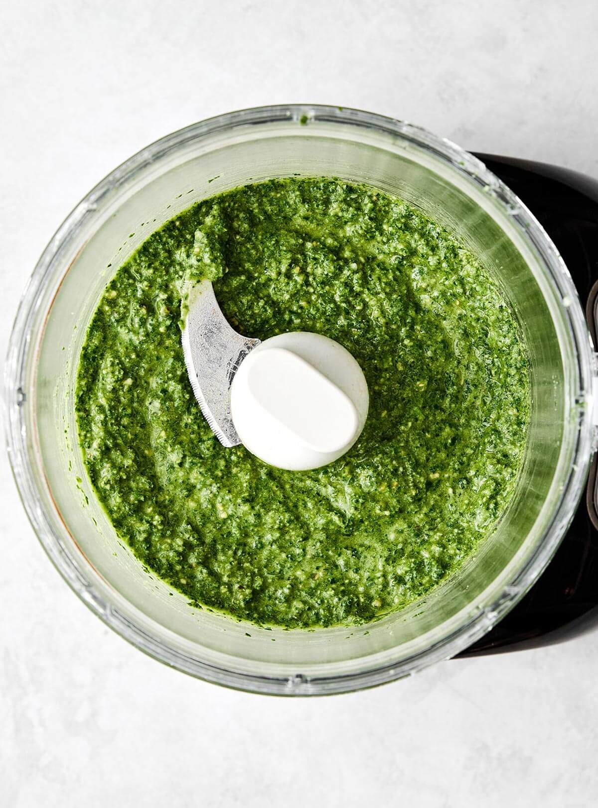 Blending basil pesto sauce.
