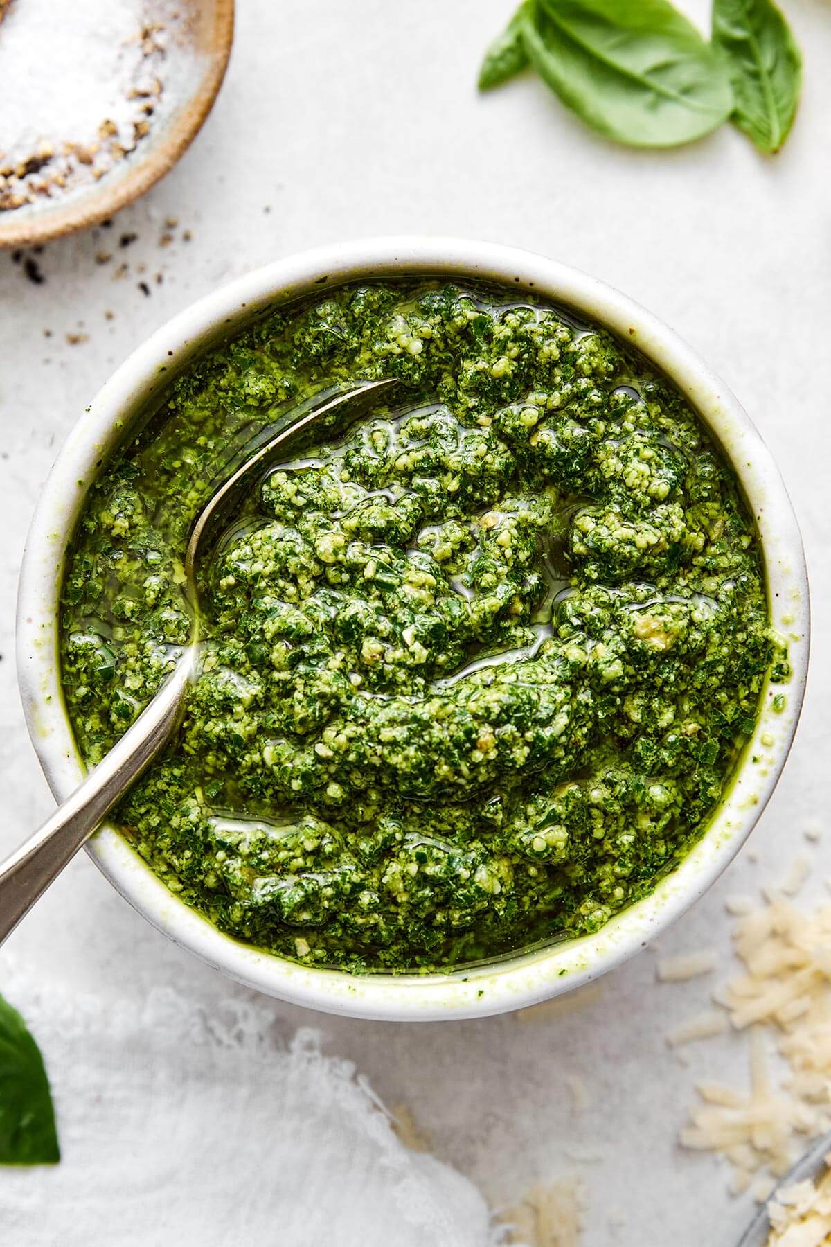 A bowl of fresh basil pesto sauce.