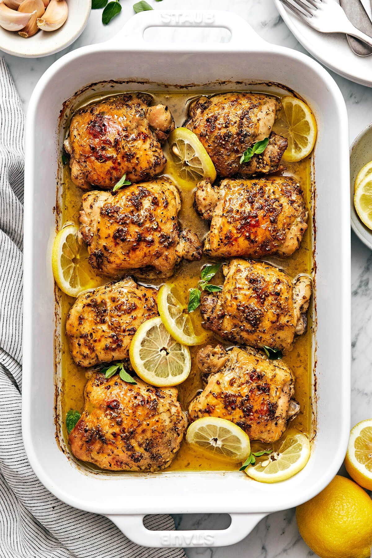 This Greek lemon chicken is the best dinner with juicy, tender, and crisp chicken thighs baked coated in a delicious lemon-herb marinade. Greek lemon chicken in a baking dish