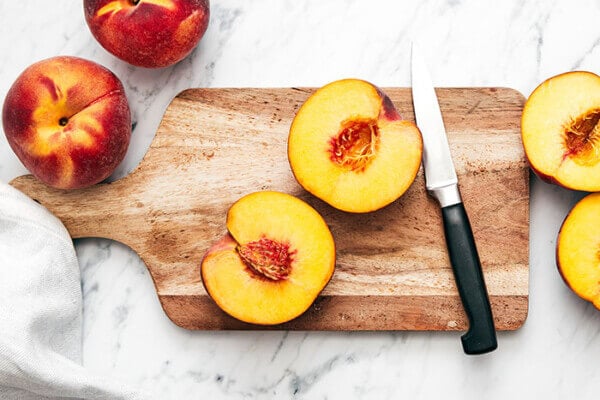 Sliced peach on a board
