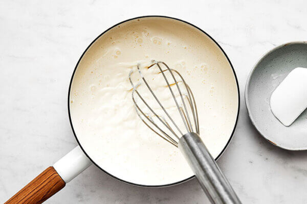 Whisking panna cotta base in pot