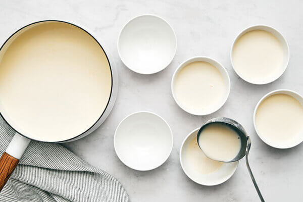 Pouring panna cotta into small bowls