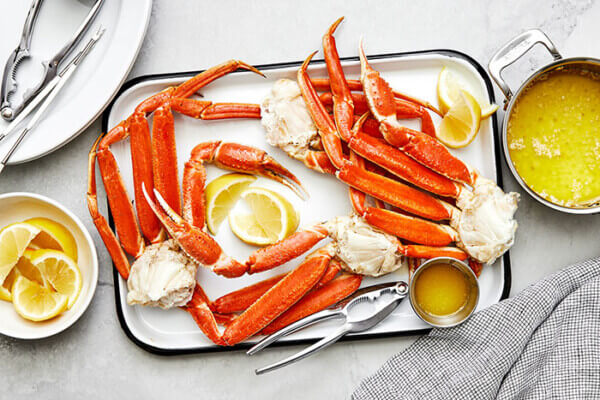 A tray of crab legs and sauce