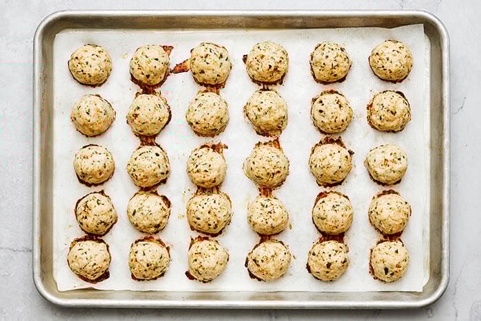 A sheet pan of baked chicken meatballs