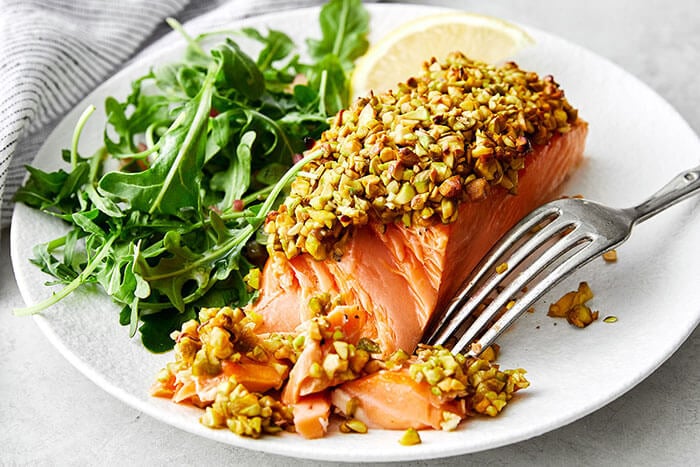 Flaked pistachio crusted salmon with arugula