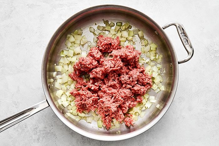 Ground beef and onions in a pan.