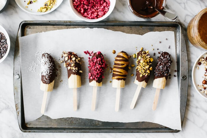 Chocolate covered bananas with different toppings