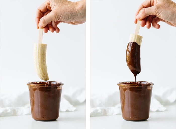 Dipping frozen bananas in melted chocolate