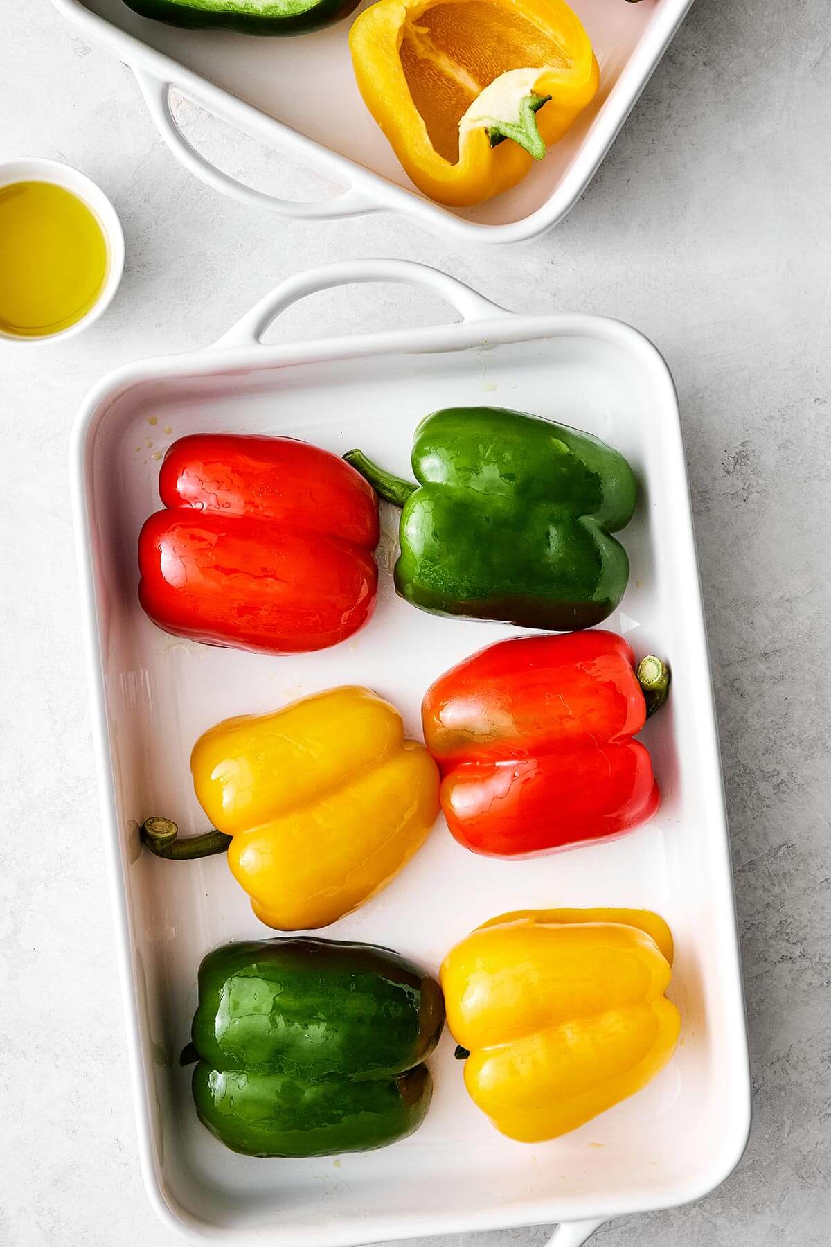 Prepping bell peppers in a baking dish.