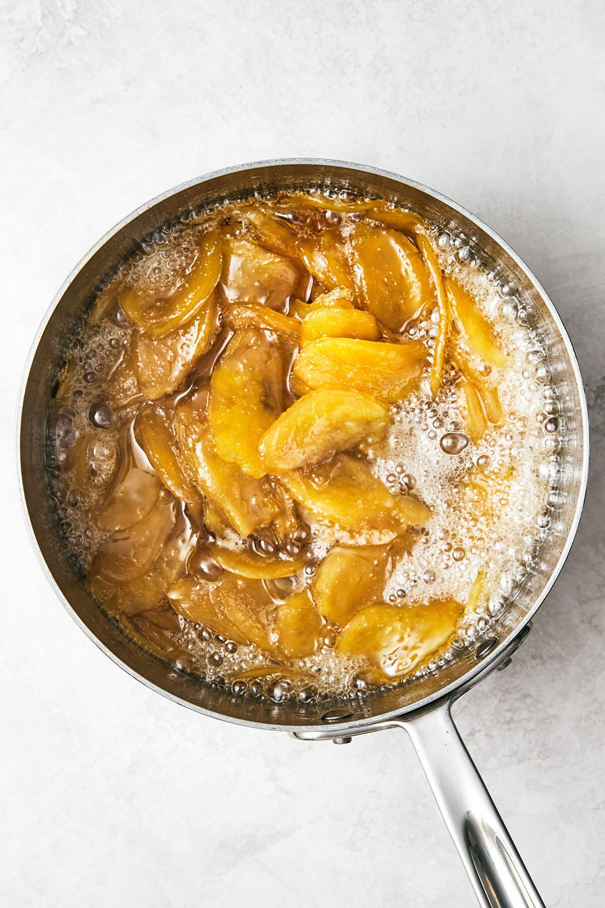 This easy homemade candied ginger is a tasty way to enjoy ginger while reaping all its shining health benefits! Making candied ginger in a pot