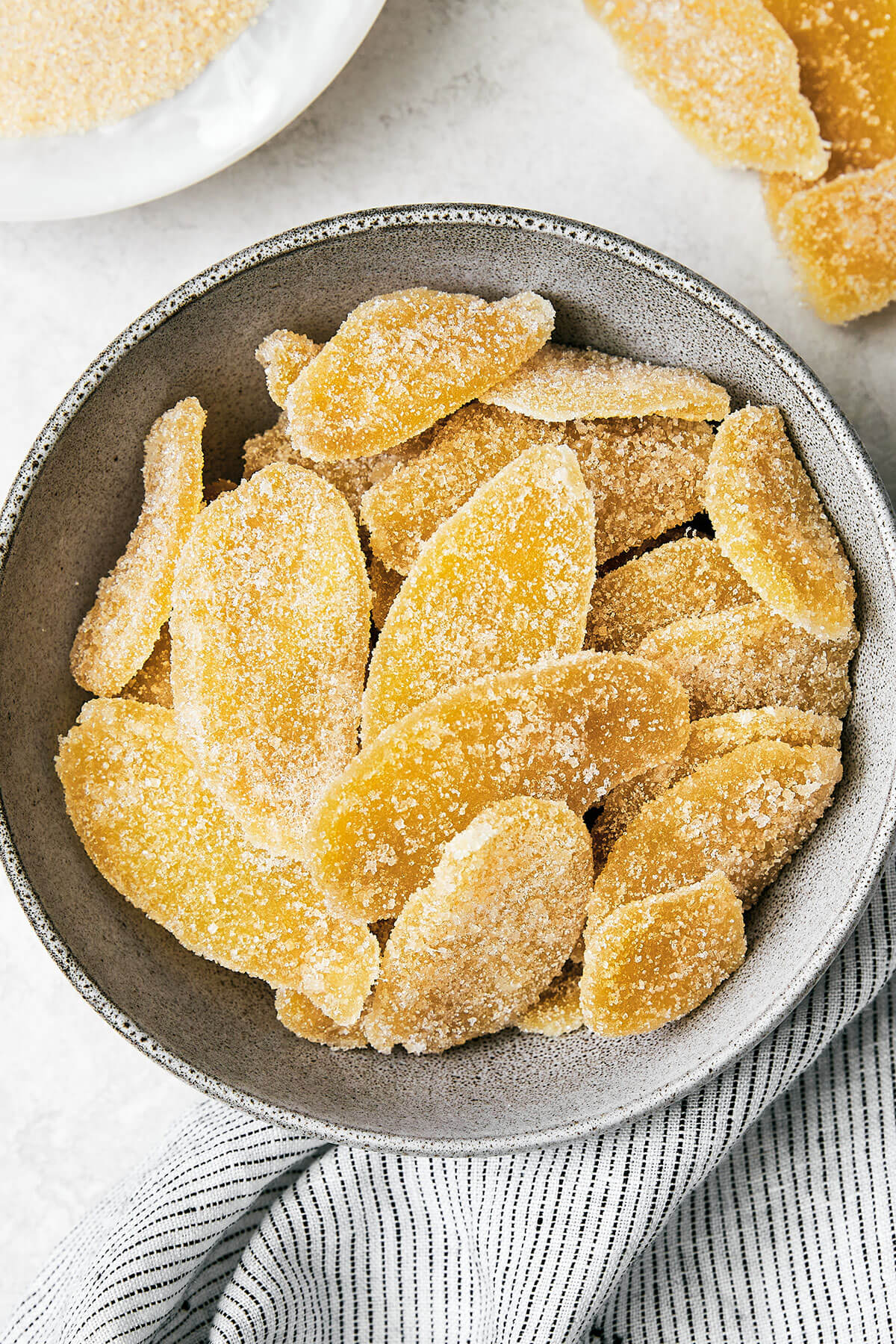 This easy homemade candied ginger is a tasty way to enjoy ginger while reaping all its shining health benefits! A bowl of candied ginger