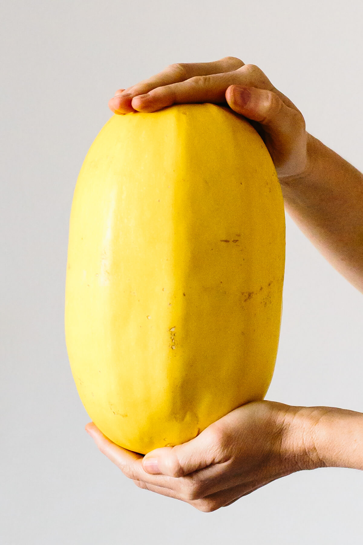 Holding a spaghetti squash.