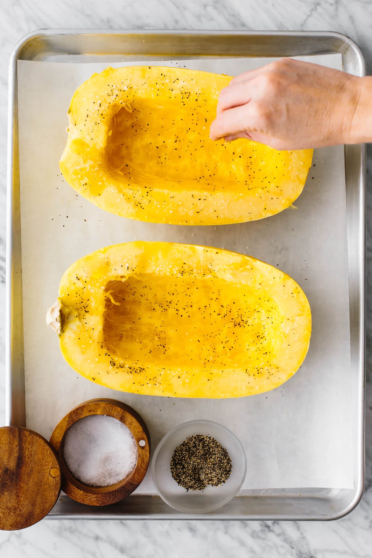 Seasoning the inside of a spaghetti squash.