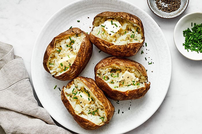 A white plate of air fryer baked potatoes