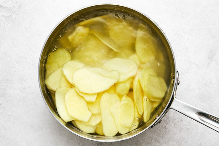 A pot boiling ginger slices