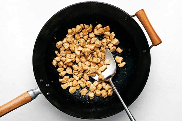 Stir fry chicken in a wok