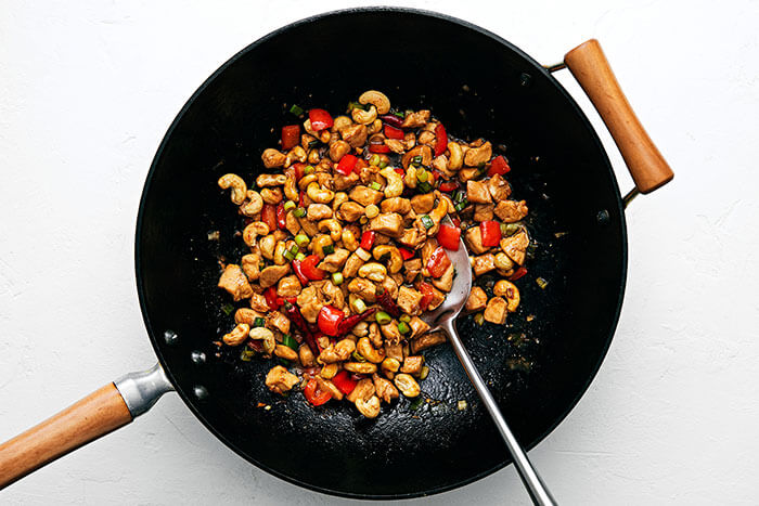 A wok with stir fry kung pao chicken