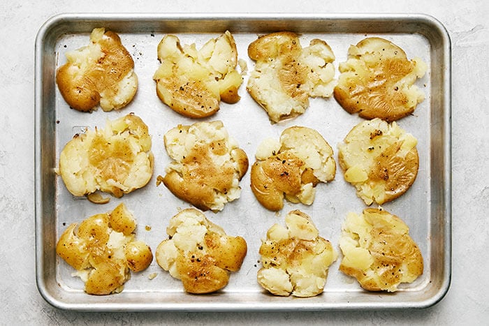 A sheet pan with smashed potatoes