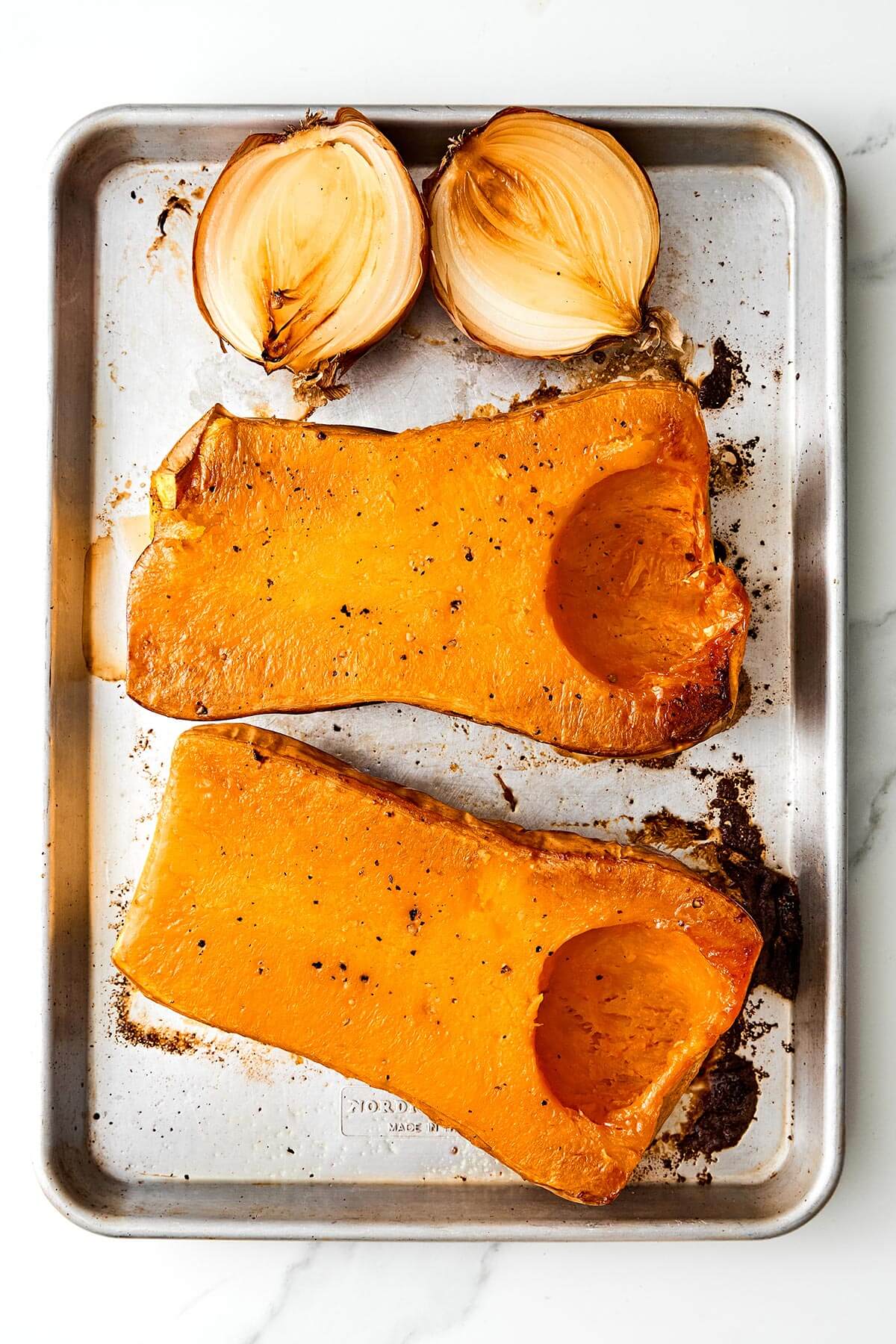 Roasted butternut squash on a baking sheet.