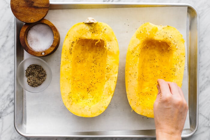 Seasoning the inside of a spaghetti squash.