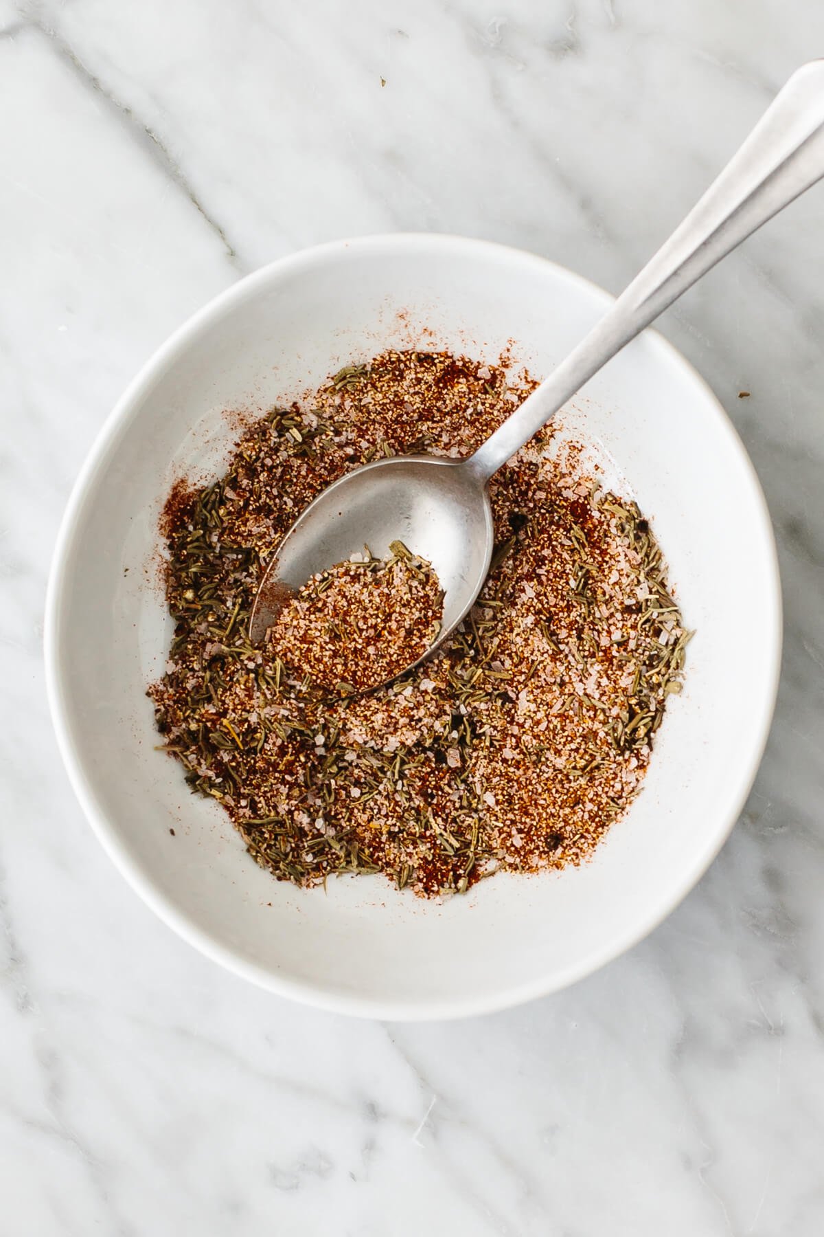 Mixing the seasonings in a bowl.