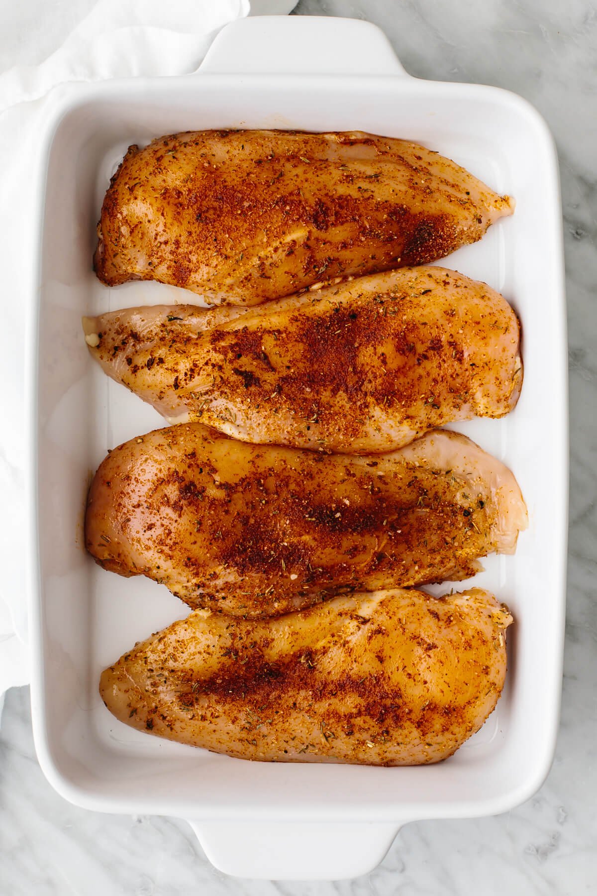 Chicken breasts in a baking dish.