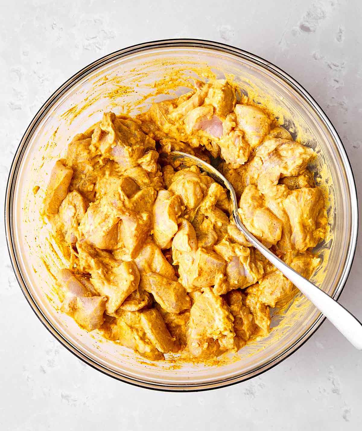 Step one: Marinating chicken in a yogurt spice blend for butter chicken.