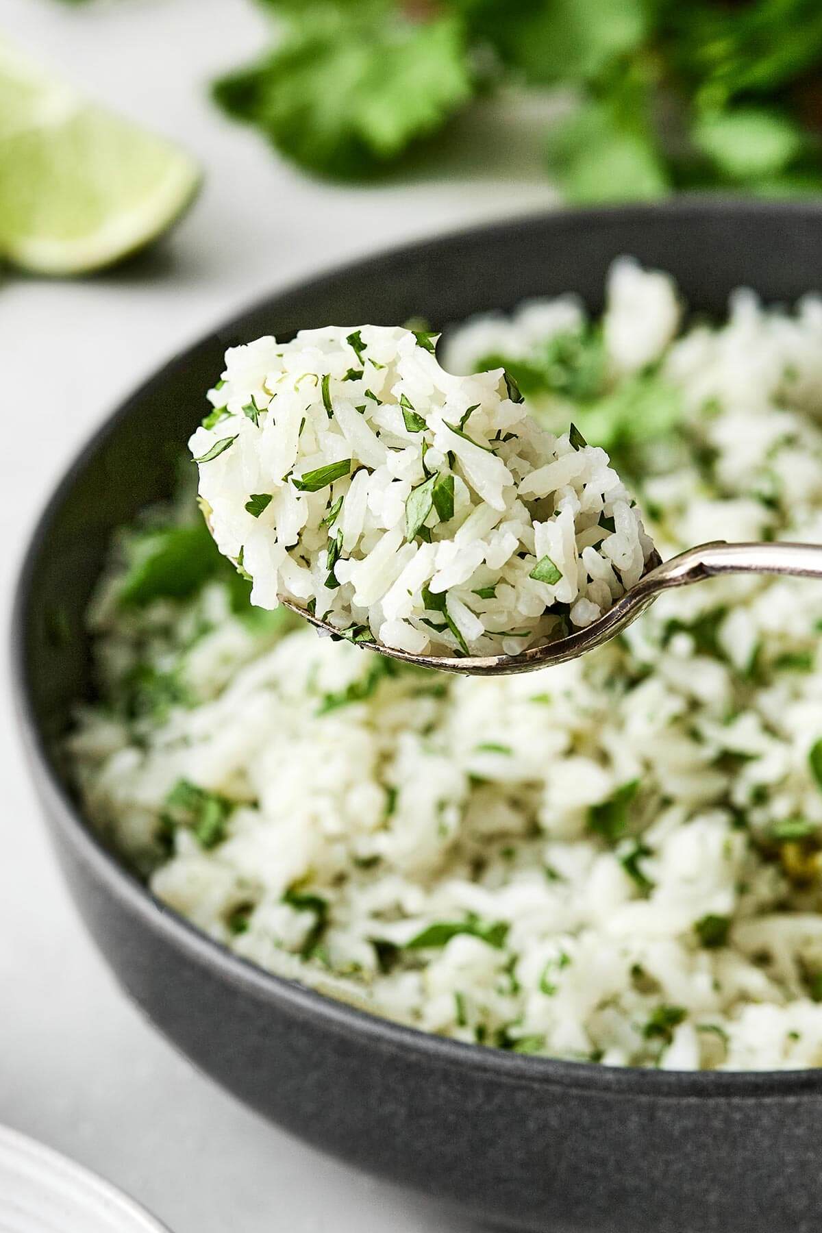 This cilantro lime rice is the best Chipotle copycat! It's bright, and zesty, and is the perfect side dish paired with Mexican mains. A spoonful of cilantro lime rice.