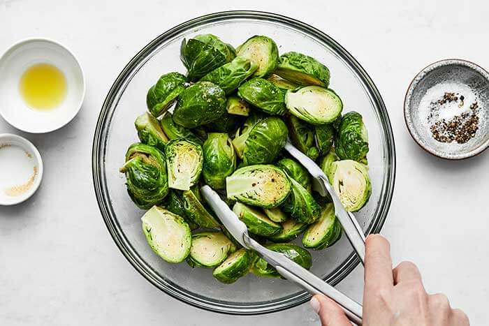 Mixing Brussels sprouts with seasoning