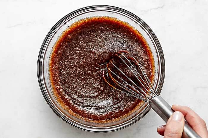 Stirring candied yams sauce.