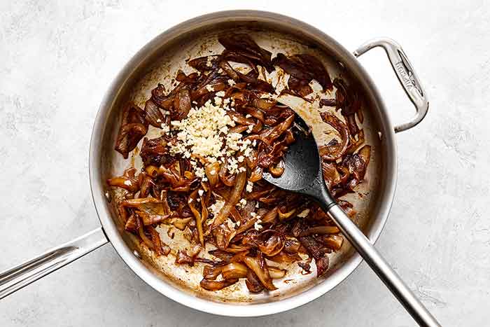 Step three of French onion dip: add garlic.