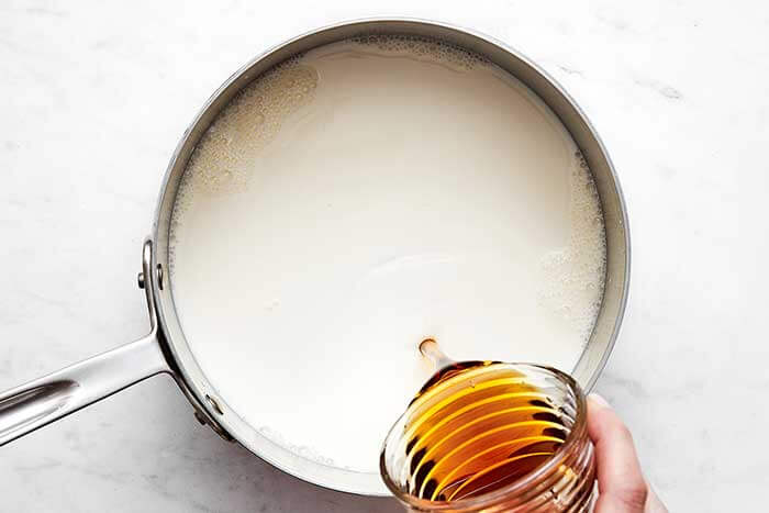 Boiled milk in a pot.