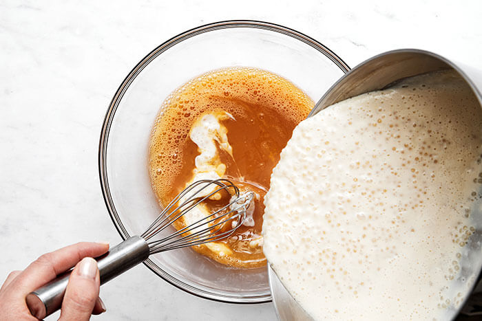 Whisking tapioca pearls into eggs.