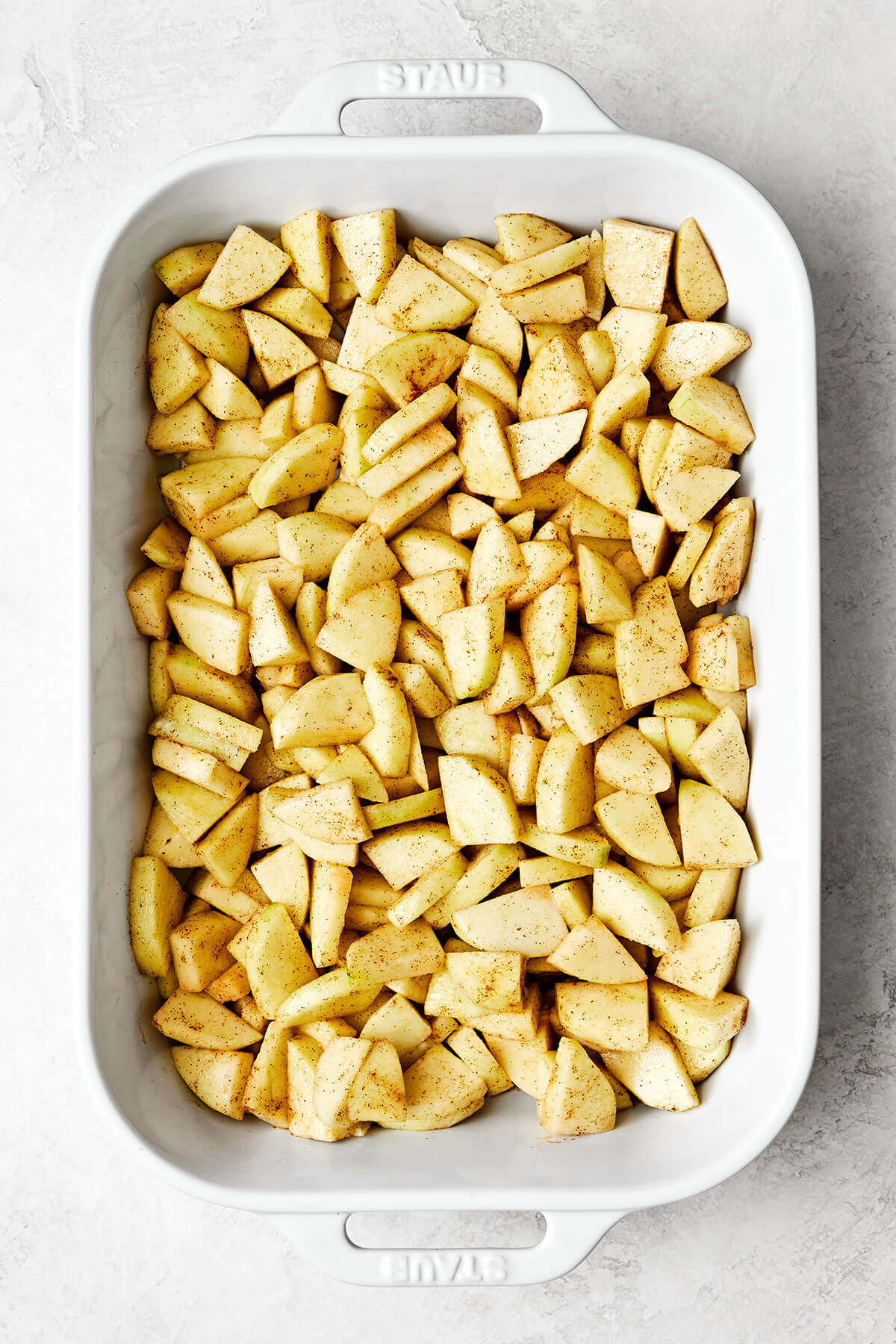 Prepping apples in a casserole dish.