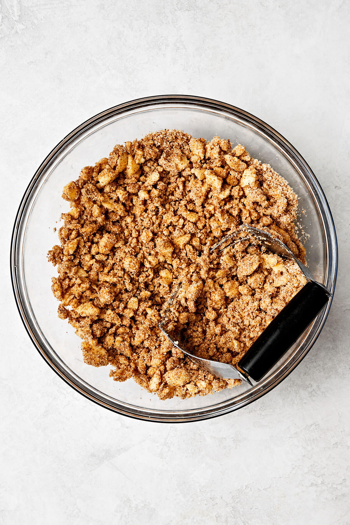 Making an apple crisp oat topping in a bowl.